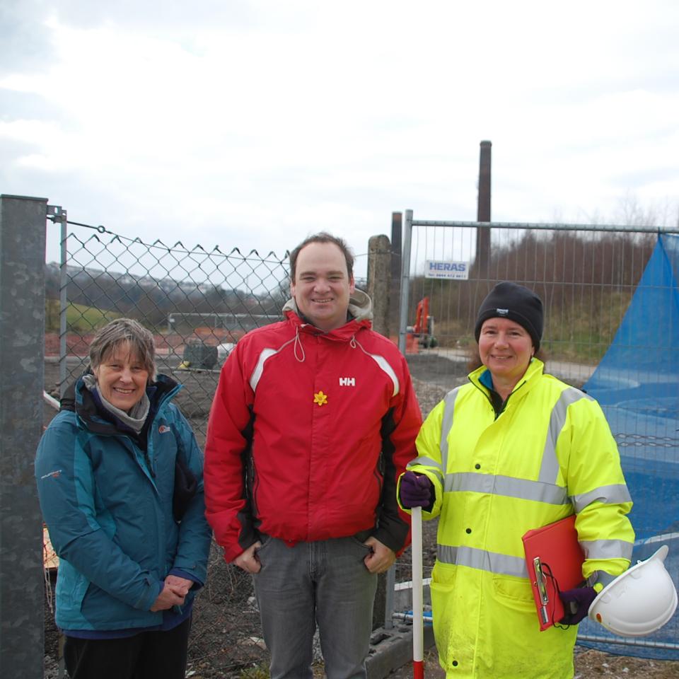 2 women and a man standing in front of a construction site