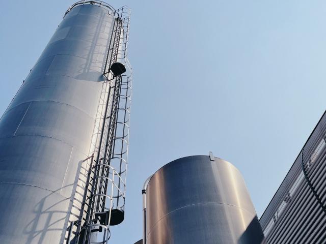 Large steel chimneys or cylinders against a blue sky