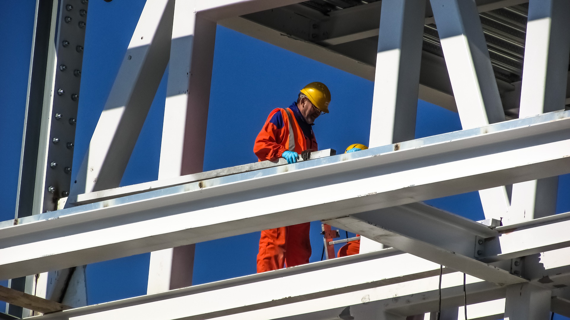 Construction site with worker in hi-vis and safety helmet