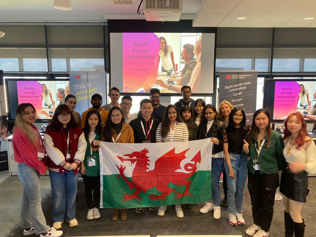 Global Wales scholars holding the Welsh flag