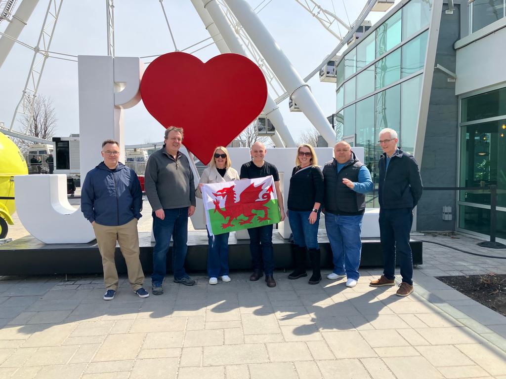 Principals and Vice-Principals holding up the Welsh flag in Montreal