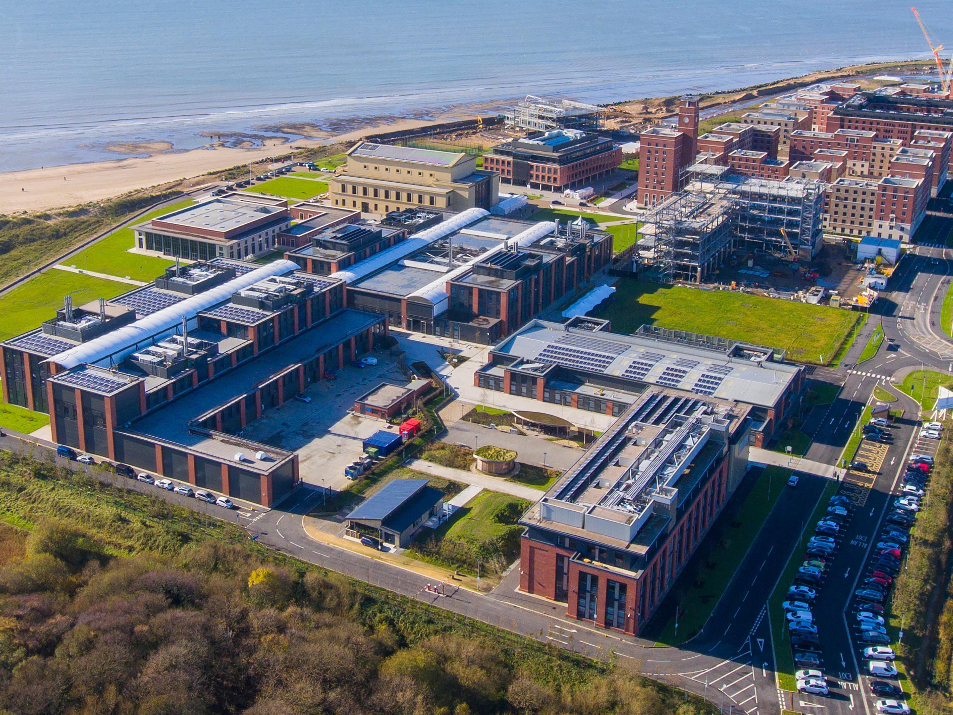 Aerial shot of Swanse Bay campus with sea in the background