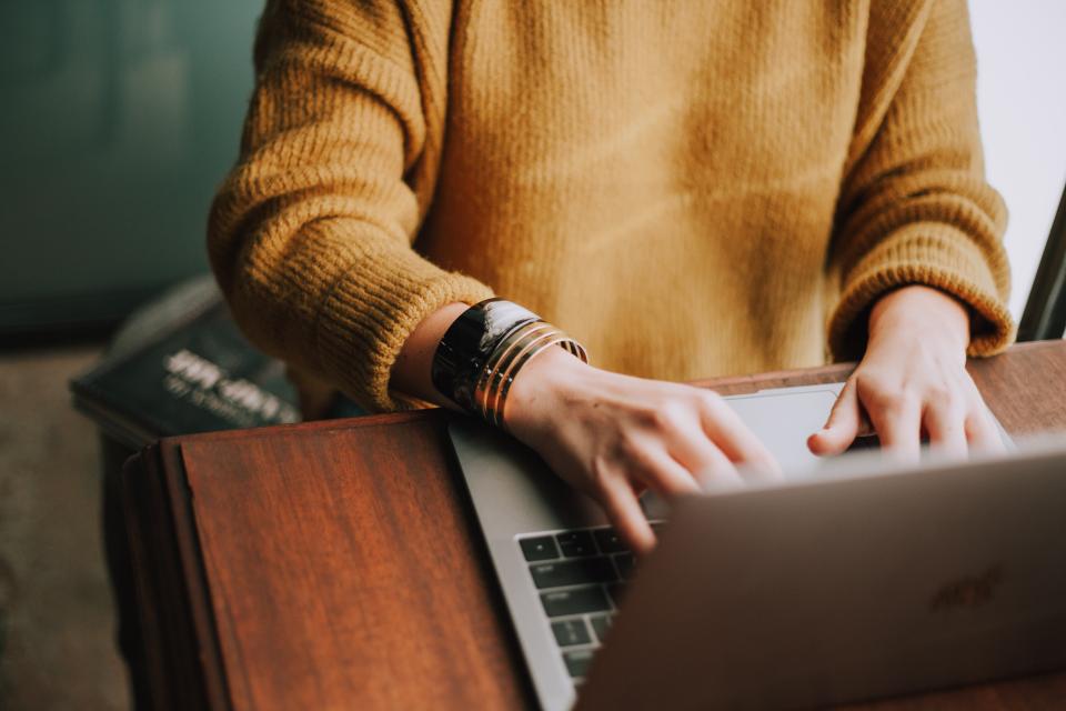 Close up shot of person working on a laptop