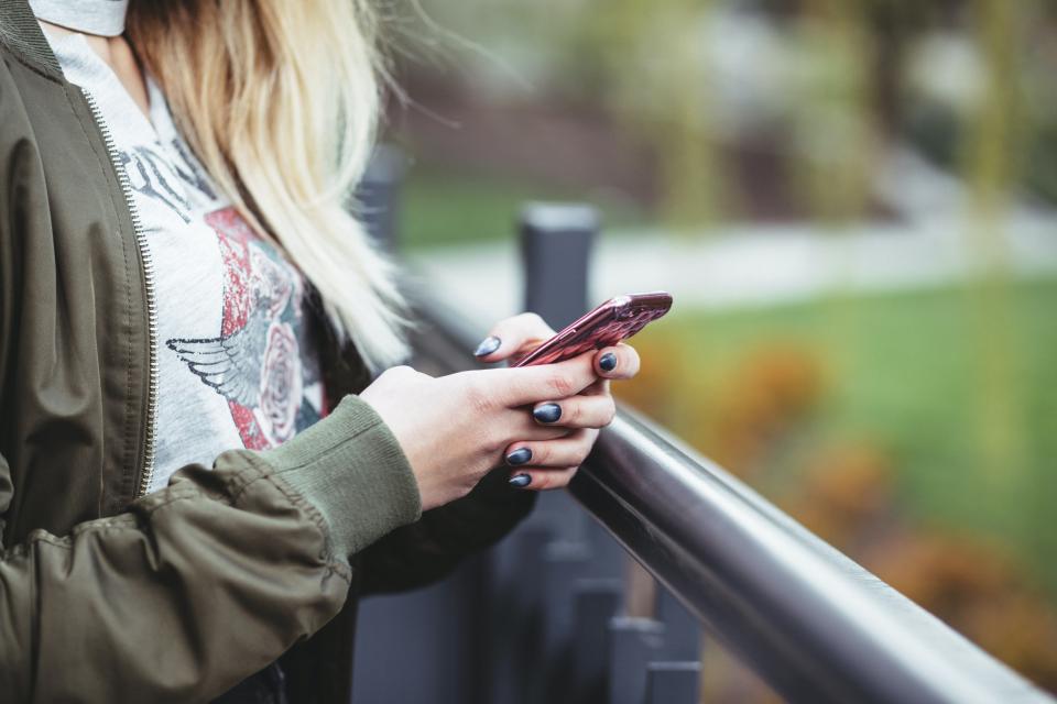 Close up shot of a woman holding a phone