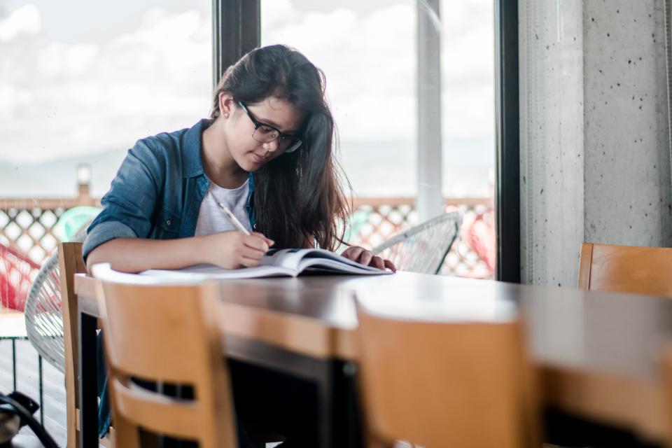 Female student sitting at a table working