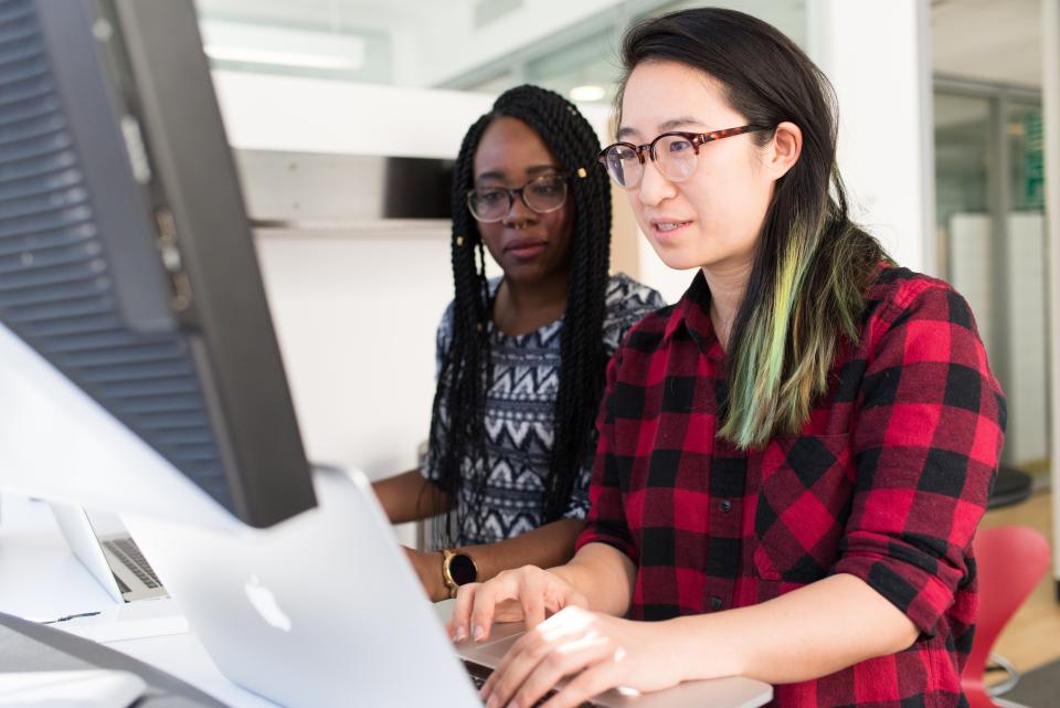 Two women sitting at a computer