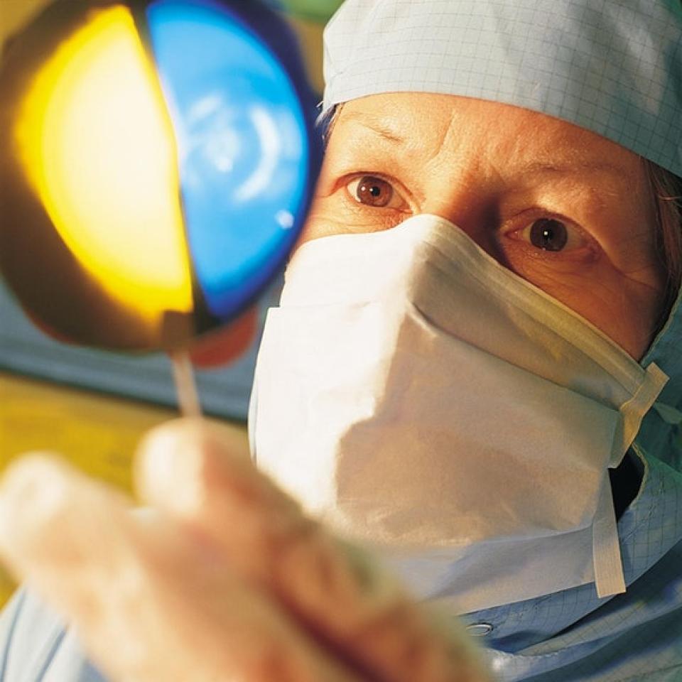 Technician holding a wafer in cleanroom close up