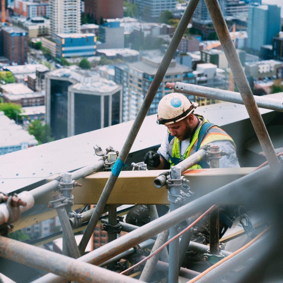 A builder working on a scaffold