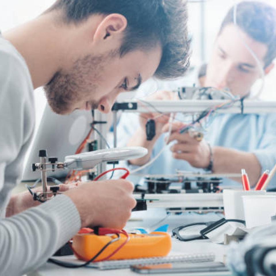 Two male engineers at a work bench