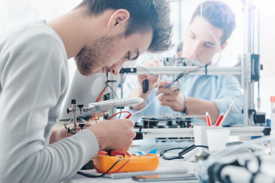 Two male engineering students working in a lab