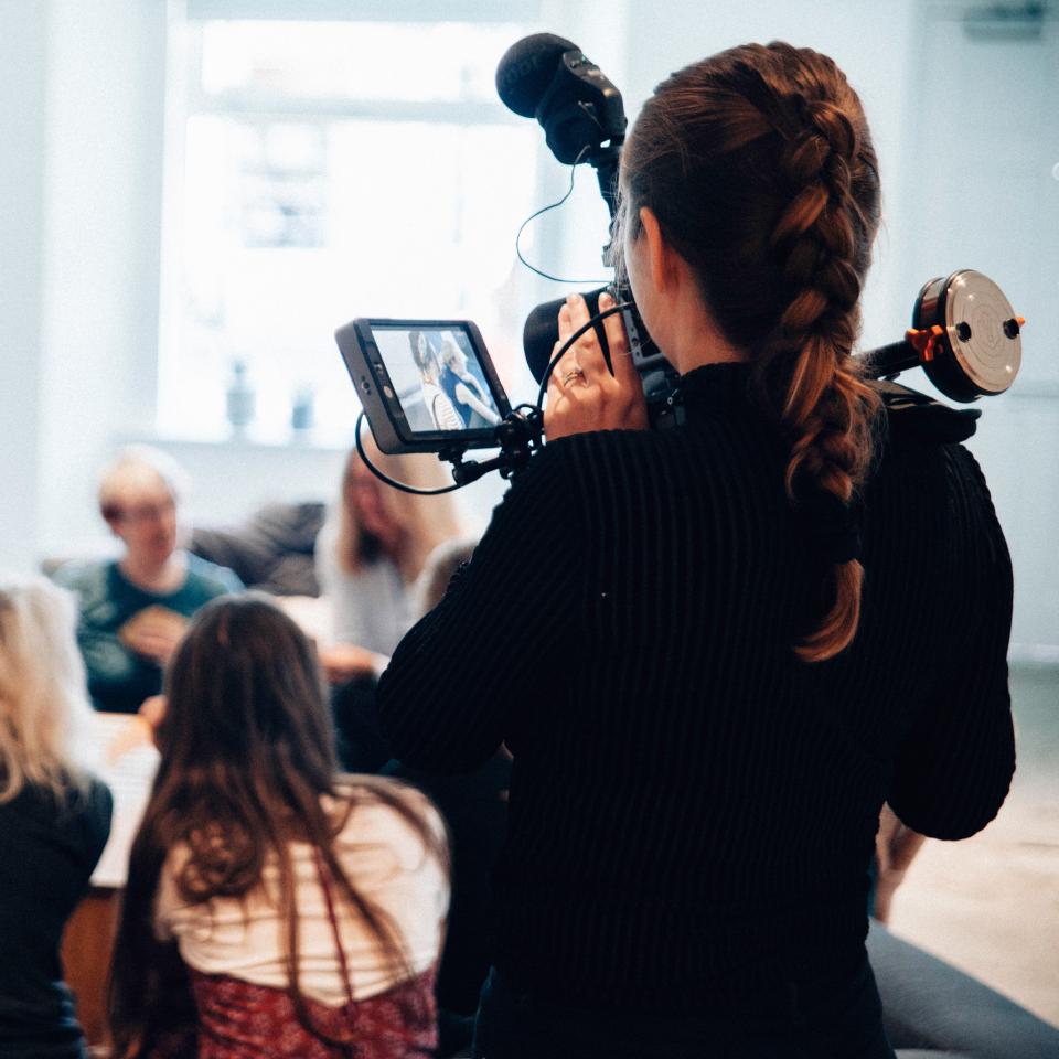 A woman filming a group of other women