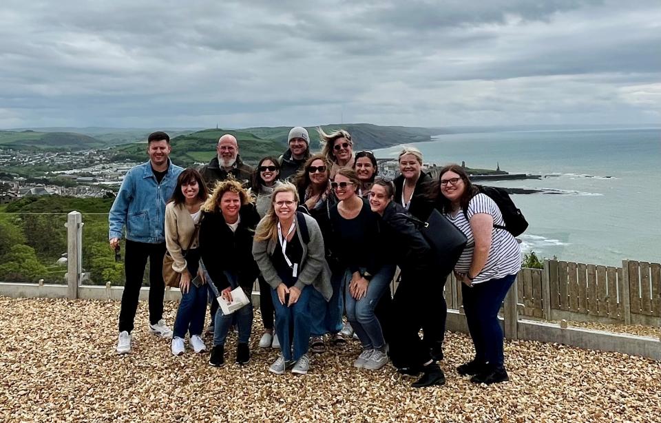 A group of people with the Welsh coast in the background