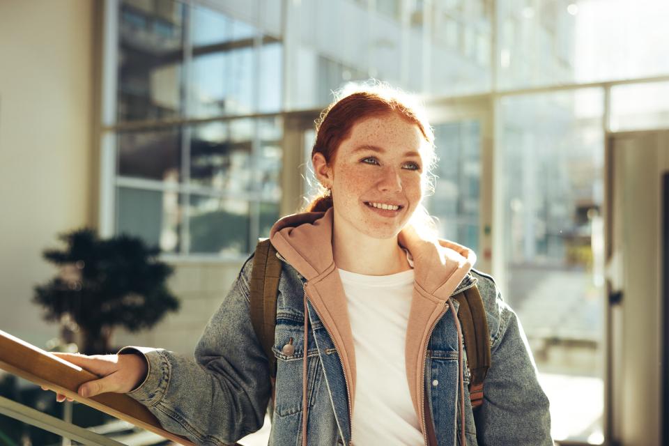 Young woman in denim jacket smiling 