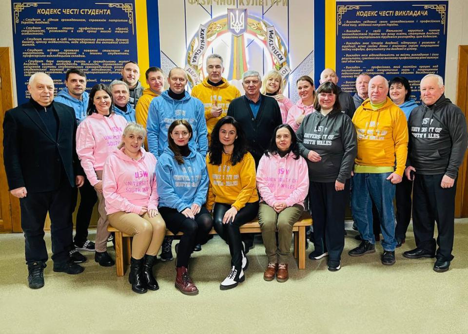 Group of people from Kharkiv State Academy of Physical Culture wearing USW hoodies