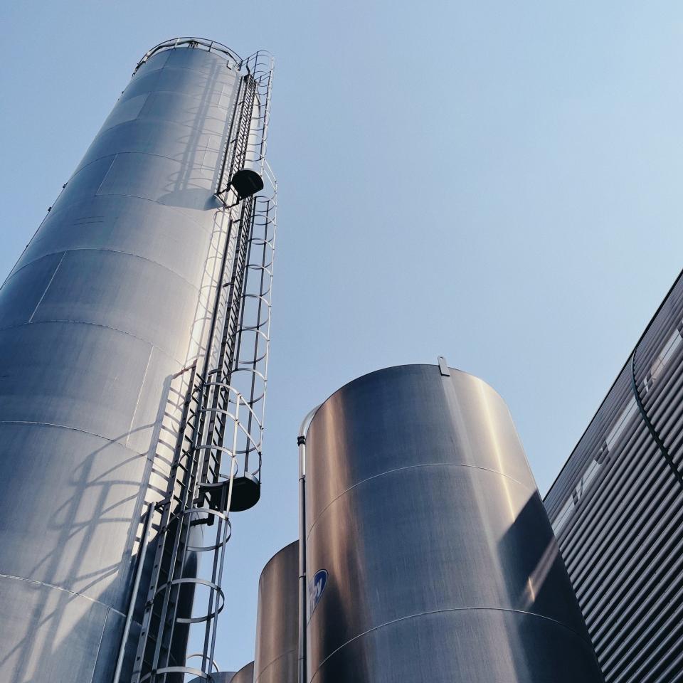 Large steel chimneys or cylinders against a blue sky