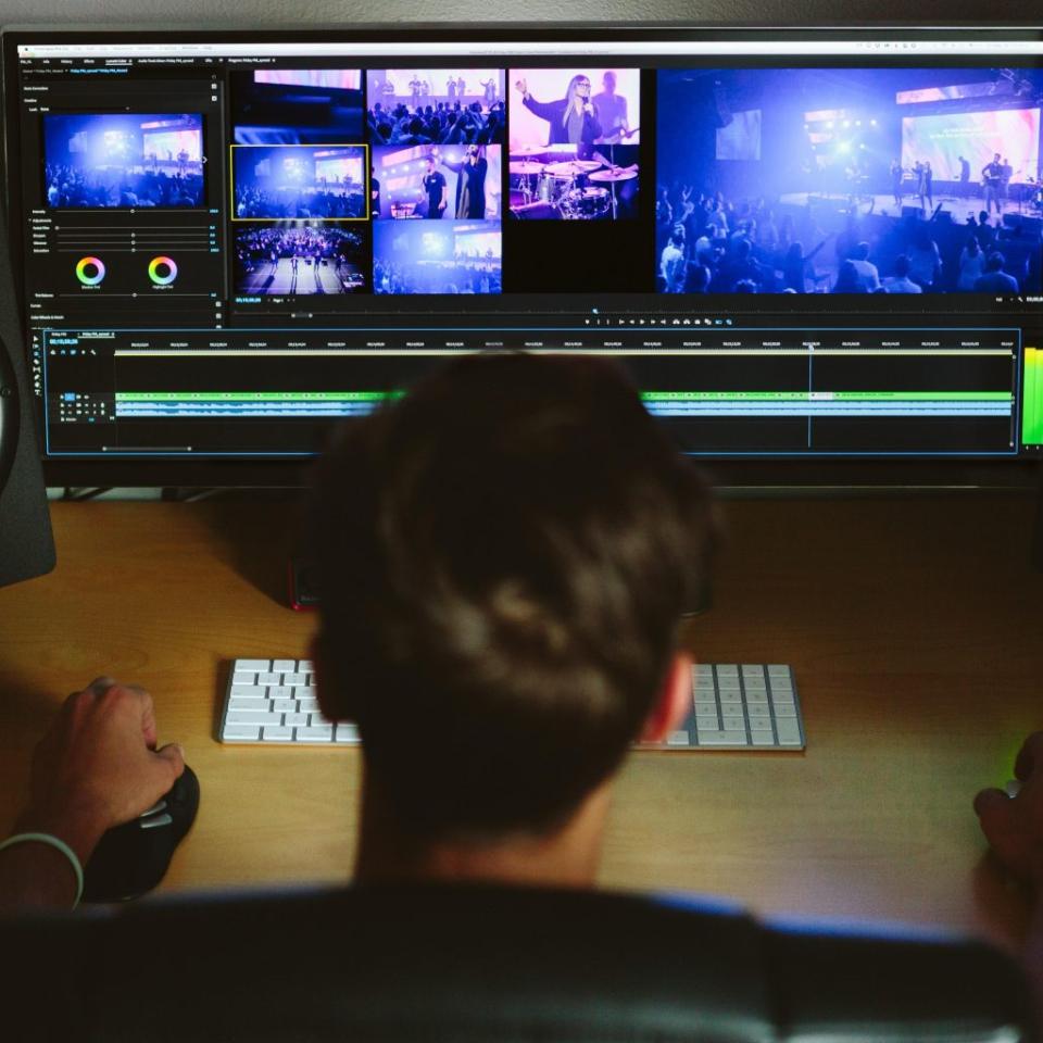 A person working at a bank of screens