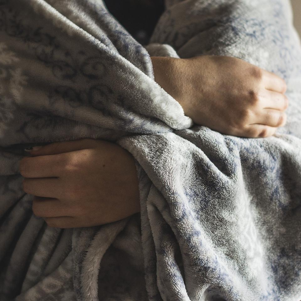 Person wrapped in a warm blanket