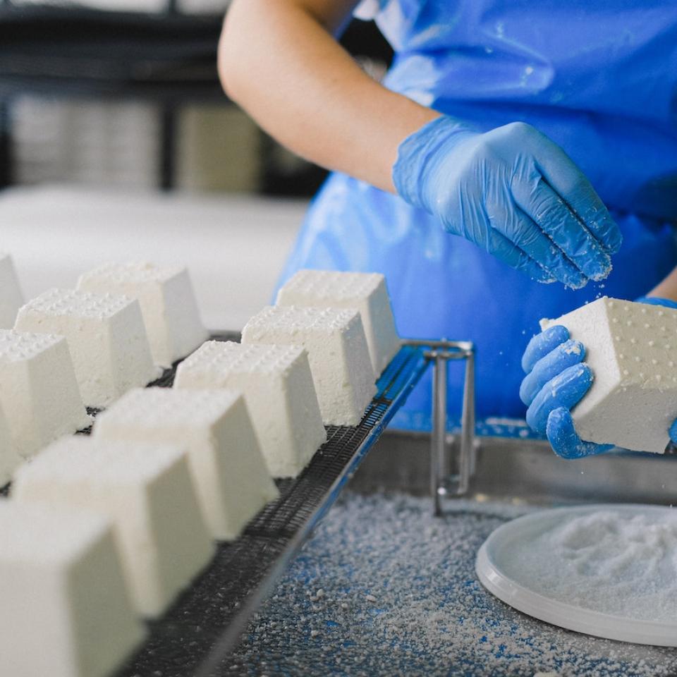 A close up shot of someone making cheeses