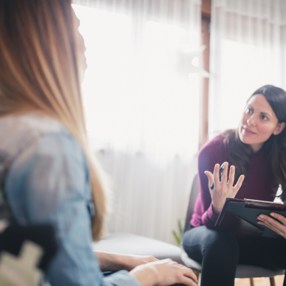 A young woman talking to a counsellor