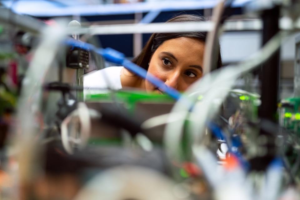 Female engineer looking through wires