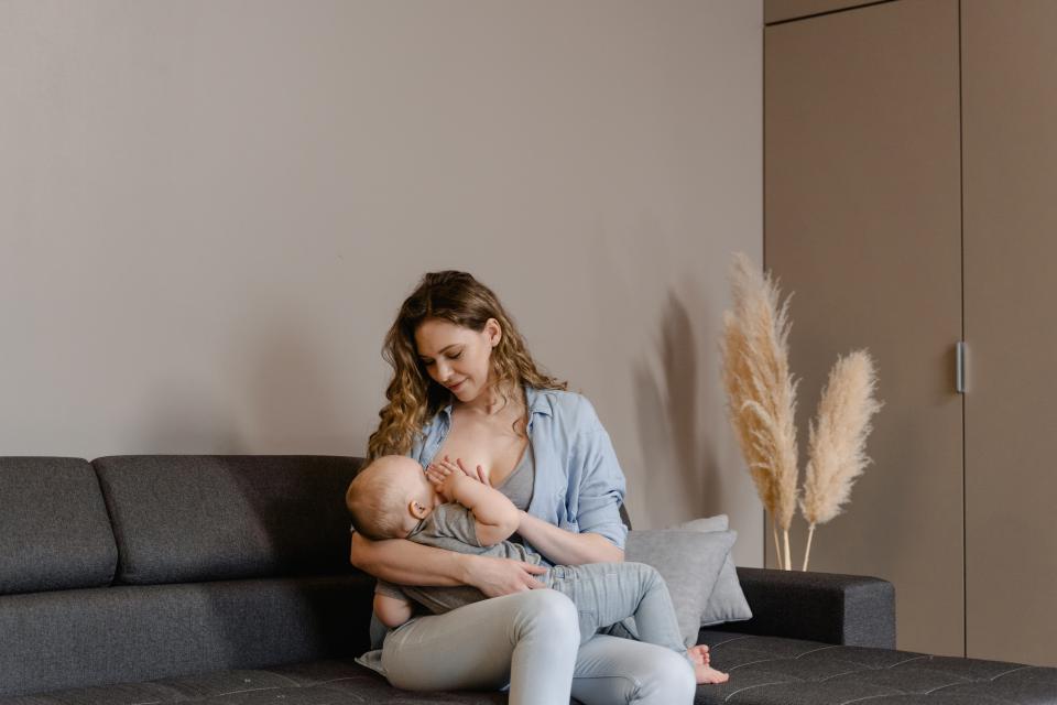 a woman breastfeeding on the sofa