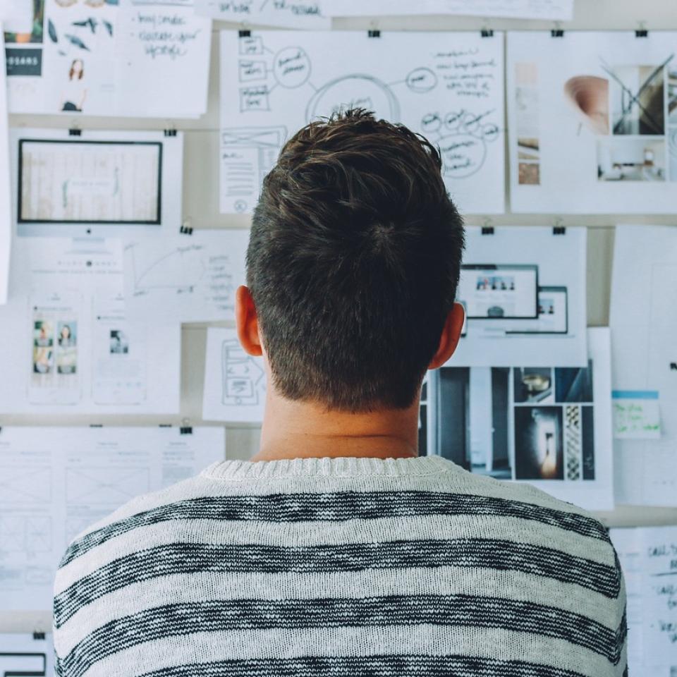 Man looking at project wall