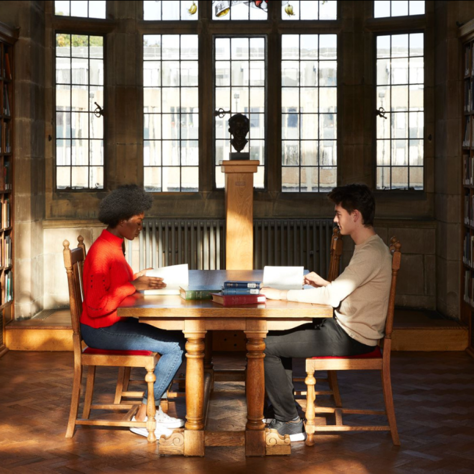 Students sitting at a table in Bangor University's library