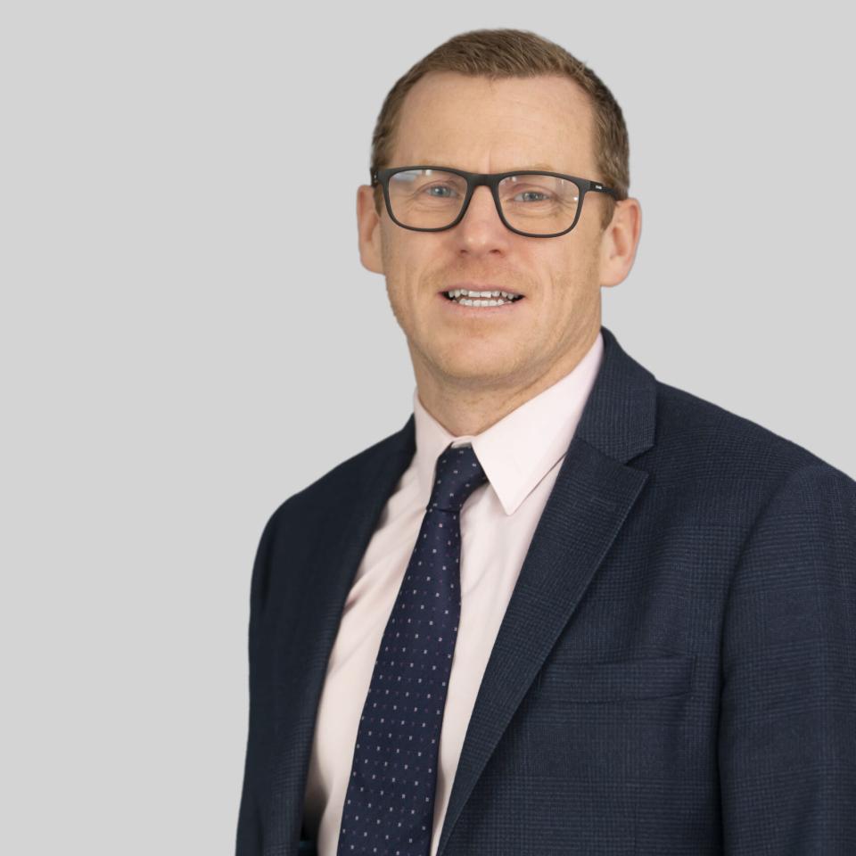Photo of James Owen against a grey background