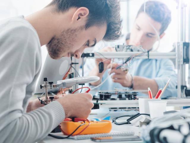 Two male engineering students working in a lab