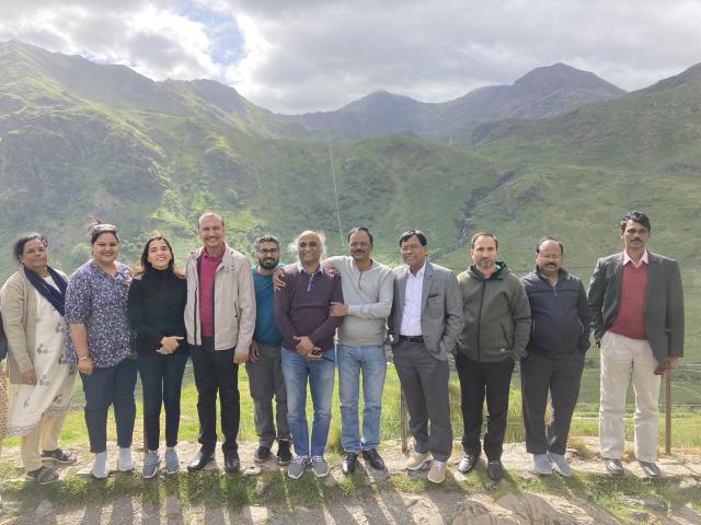 Telangana delegation standing in line with mountains in the background