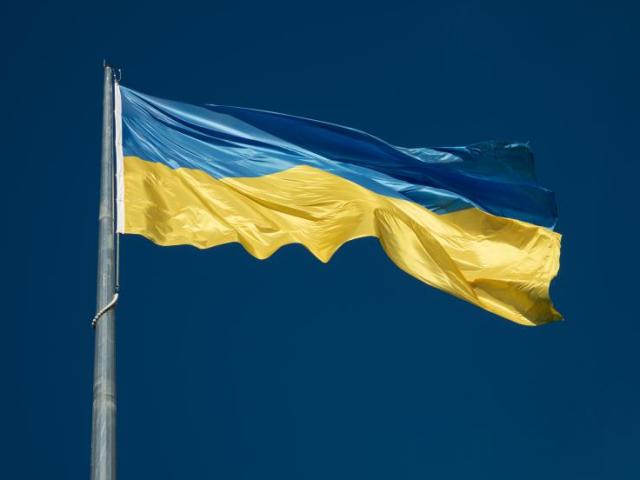 Ukraine flag against blue sky