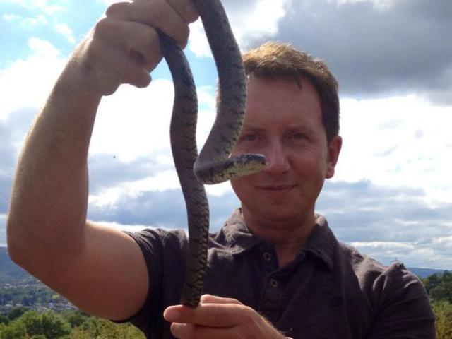 Rhys Jones holding up a snake