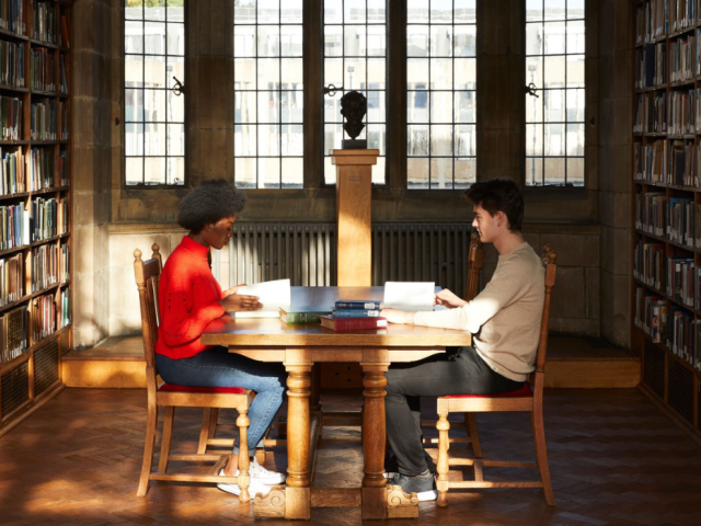 Students sitting at a table in Bangor University's library